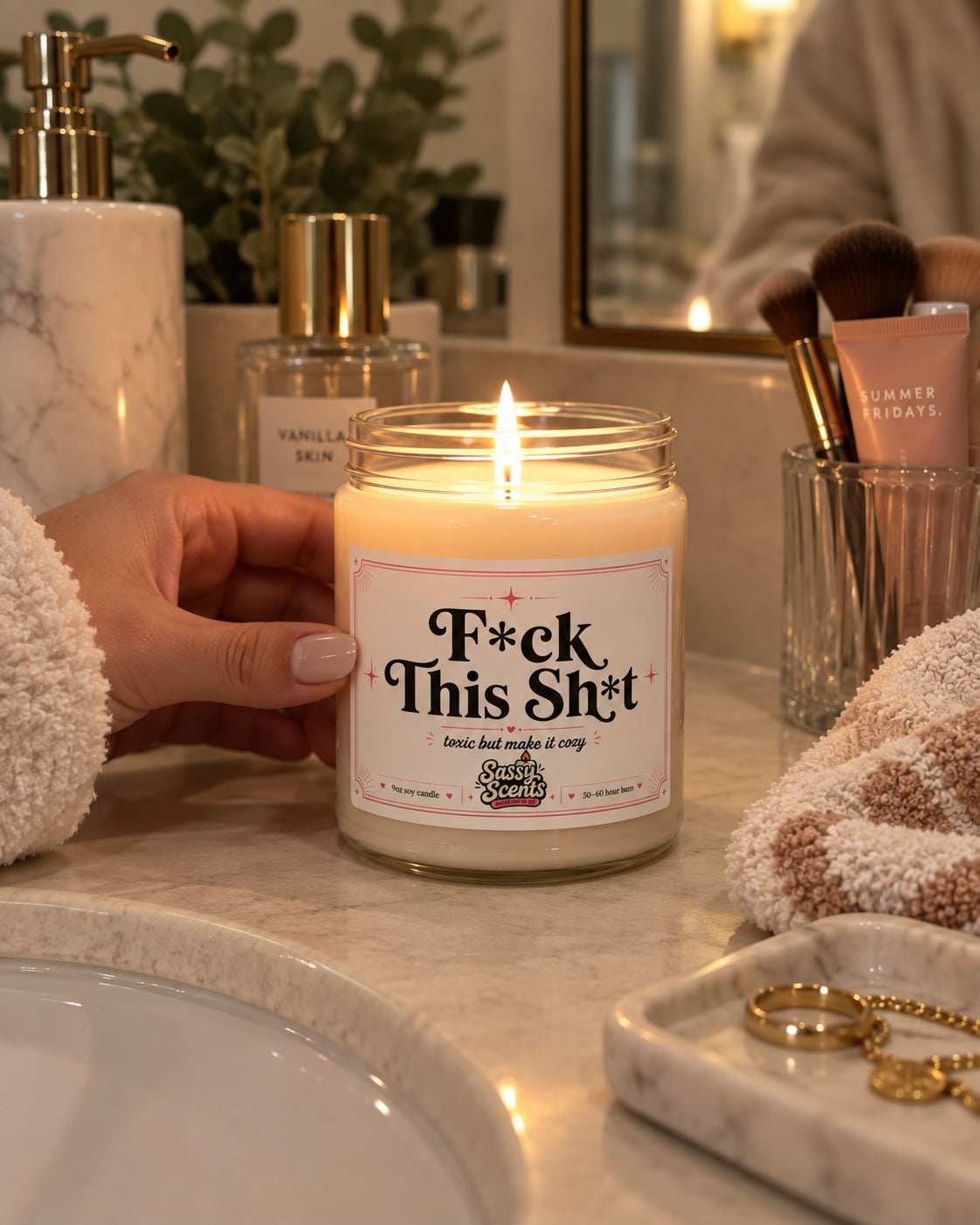 F*ck This Sh*t soy candle burning on a marble vanity
