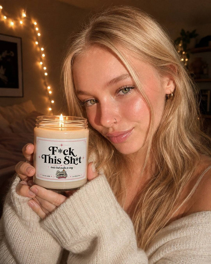 Customer holding a candle in front of fairy lights