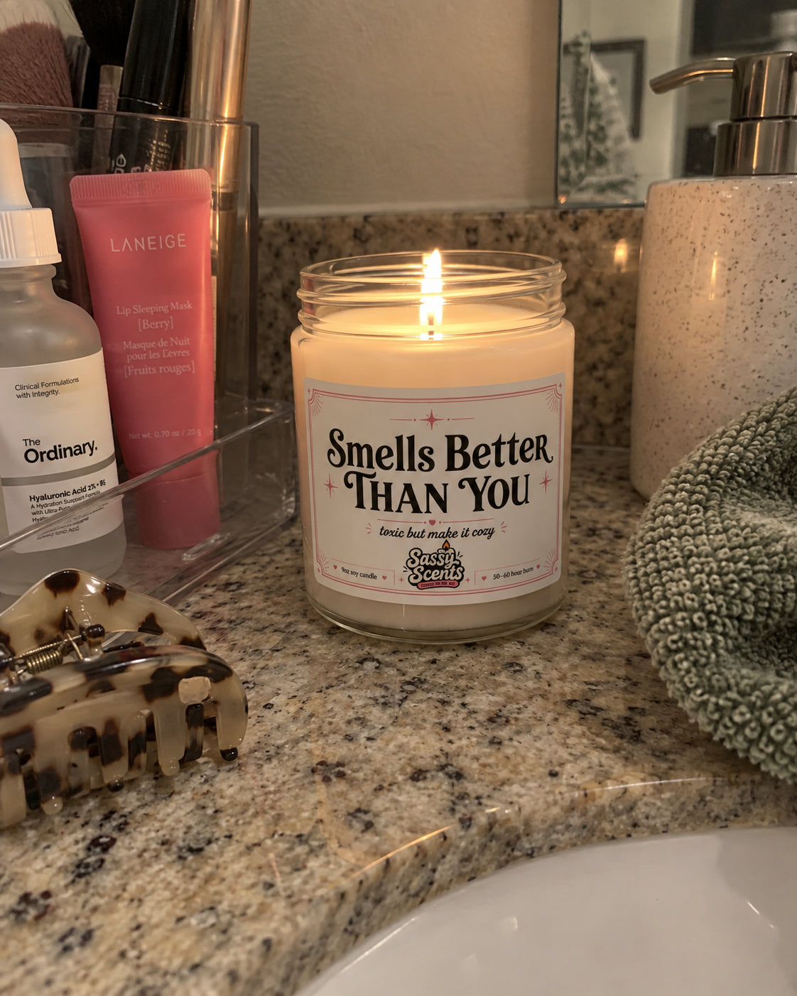 Sassy Scents candle glowing against a dark background