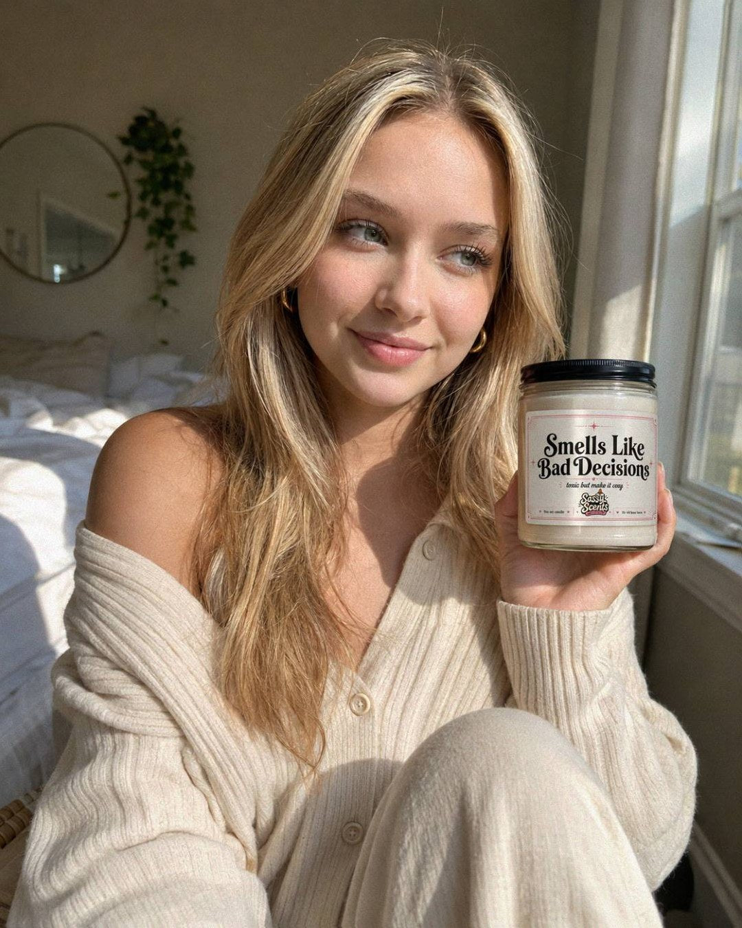Customer holding a Sassy Scents candle in warm daylight
